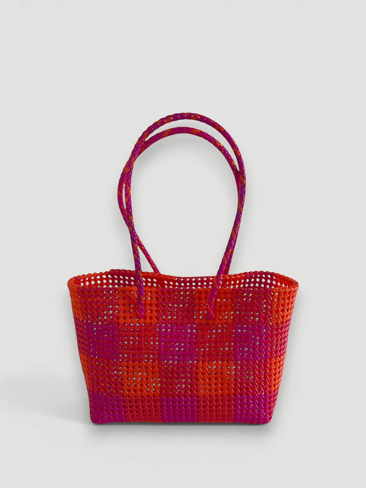 MOKA large hand-woven basket bag in dark pink and orange recycled plastic and silk with braided handles.